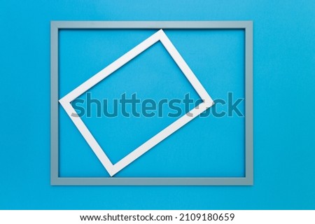 White frame rotated in a light blue frame on a vibrant blue background