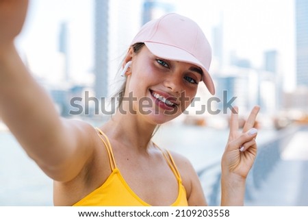 Young beautiful woman weared sporty take a selfie picture on her smartphone