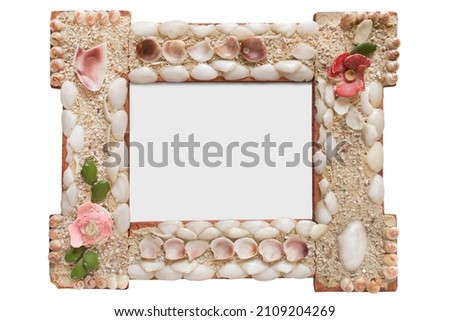 Empty old wood picture frame decoated with seashells isolated over white