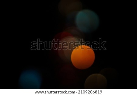 Bokeh of light on a black background taken at night.