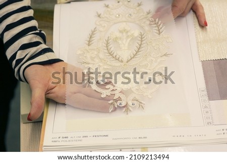woman hand choosing curtain and accessories samples for window design close up photo