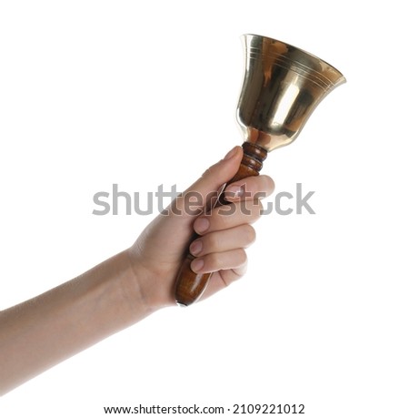 Woman ringing school bell on white background, closeup Royalty-Free Stock Photo #2109221012