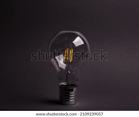 A closeup shot of a modern lightbulb isolated on a gray background