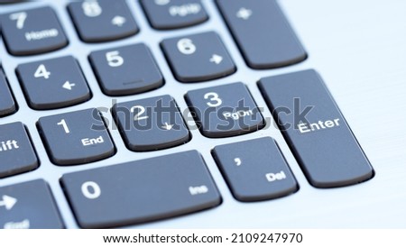 Keys on laptop keyboard macro photography. Numeric keypad close-up. Office work concept. Counting the economic efficiency of a business or startup concepе. The concept of computerized accounting.  Royalty-Free Stock Photo #2109247970