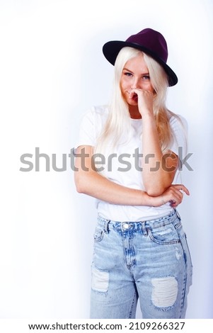 young pretty stylish blond hipster girl in hat posing emotional isolated on white background, lifestyle people concept