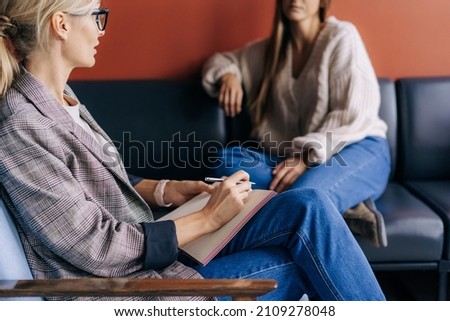 The psychologist makes a social survey of the reference group. A professional is talking to a client. Informal communication at the interview, business consultant writes notes in a notebook. Royalty-Free Stock Photo #2109278048