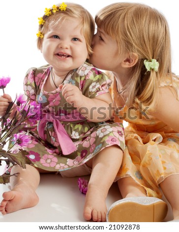 Pretty little girl kissing her sister