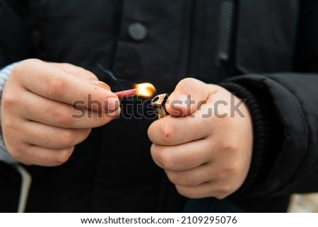 the child lights a firecracker