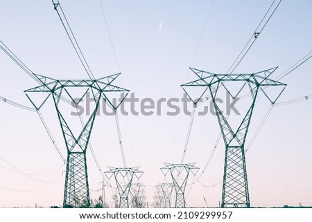 Pylons of two high-voltage current lines. Royalty-Free Stock Photo #2109299957