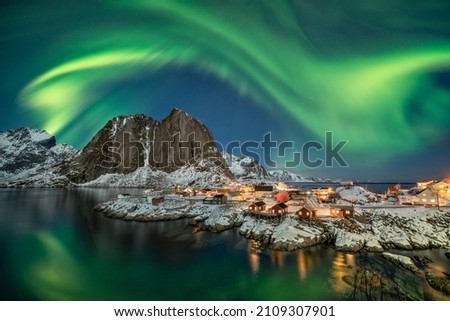 Strong magical Northern Lights flying over red rorbuer at Hamnoy Royalty-Free Stock Photo #2109307901