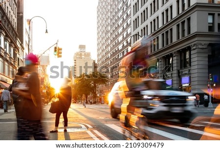 Fast paced scene with people bike and cars at the busy intersection of 14th Street and 5th Avenue in New York City NYC Royalty-Free Stock Photo #2109309479