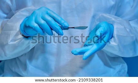 scalpel in the hands of a surgeon