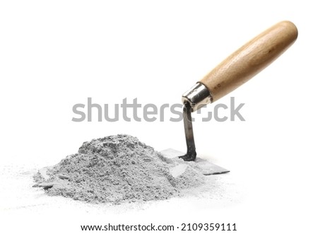 Cement pile and trowel isolated on white   Royalty-Free Stock Photo #2109359111
