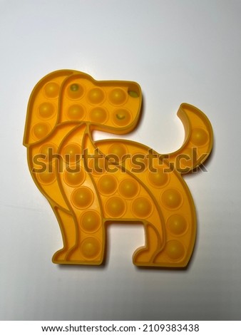 Yellow Plastic pop it toy dog made of composition on white background different perspective combo macro Detail shot abstract pastel perfect interesting different background images child's play buying