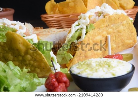 Mexican food, guacamole, nachos, tacos, chili tortillas and quesadillas with salad