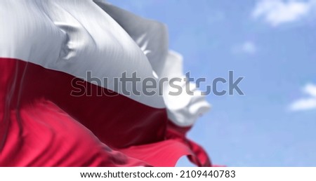 Detail of the national flag of Poland waving in the wind on a clear day. Democracy and politics. European country. Selective focus. Royalty-Free Stock Photo #2109440783