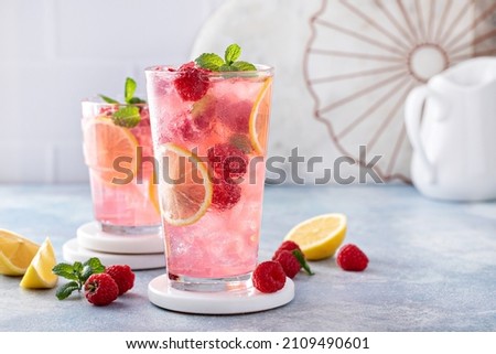 Spring or summer refreshing cold cocktail or mocktail with berries and lemon, raspberry lemonade Royalty-Free Stock Photo #2109490601
