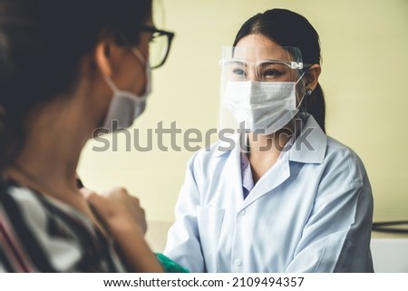 Young woman visits skillful doctor at hospital for vaccination . Covid 19 and coronavirus vaccination center service concept .