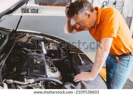 garage mechanic worker stress with problem car engine fail  Royalty-Free Stock Photo #2109538601