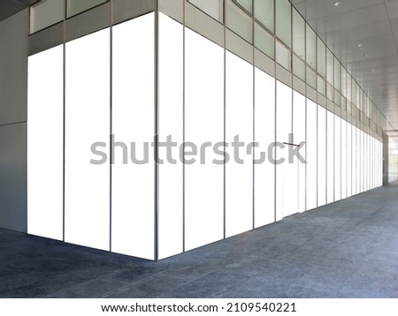 Blank advertisement mock up on glass wall panels of a modern office building in the central business district