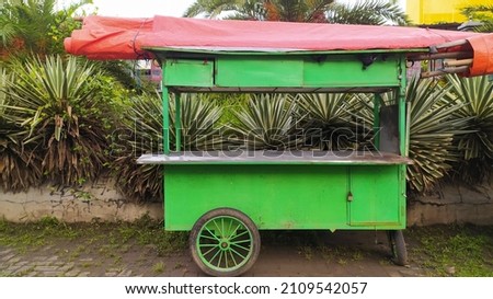 A cart used to trade traditional food is in a park located in Sukoharjo, Indonesia. Royalty-Free Stock Photo #2109542057