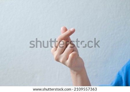 The hand of the person doing the I Love You pose.