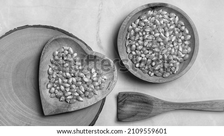 Black and white, Corn kernels in a wooden bowl that are ready to be processed into a delicious snack, Good arrangement gives an attractive impression.Food and drink concept. Art Photography. Flat lay