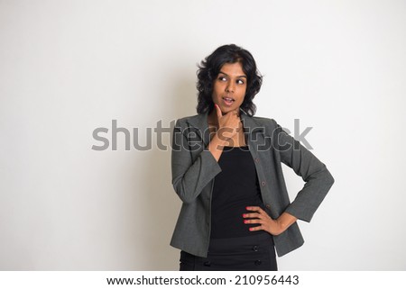 indian business woman thinking with plain background