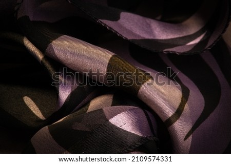 silk fabric in abstract brown and blue-yellow tones. Abstract watercolor paint, painted textured vertical silk fabric, canvas, macro, close-up, pastel. Texture. Background. Pattern.
