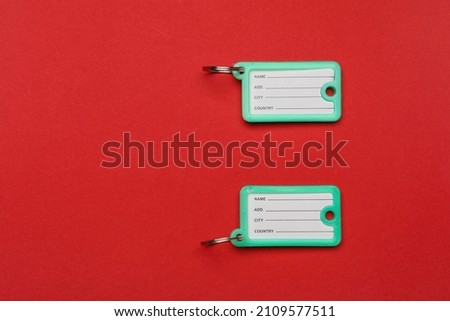 Plastic key tags on color background