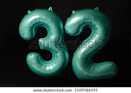 Figure 32 made of color balloons on black background