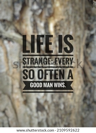 Inspirational life quote 'Life is strange; every so often a good man wins.' on blurry background.