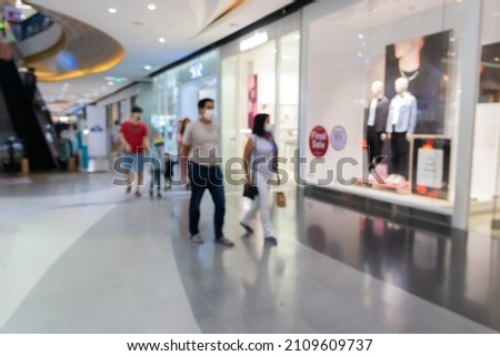 Abstract blurred shopping mall in department store interior for background.