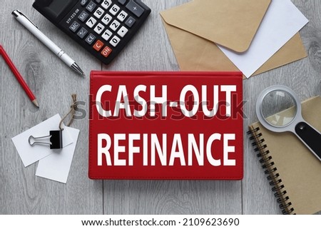 CASH-OUT REFINANCE red notepad on wood background with envelope and calculator Royalty-Free Stock Photo #2109623690