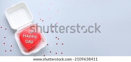 Plastic box with tasty bento cake on grey background with space for text