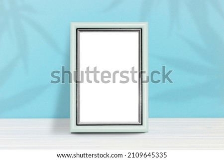 Poster template. Photo frame on a wooden table