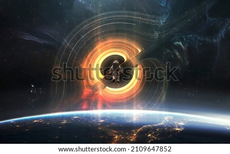 Giant black hole threatens planet earth. Brave astronaut. 5K realistic science fiction art. Elements of image provided by Nasa