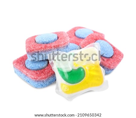 Dishwasher detergent pod and tablets on white background