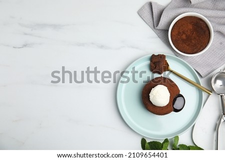 Delicious fresh fondant with hot chocolate and ice cream on white marble table, flat lay. Space for text