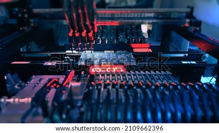 Machine Vision System inspect PCB for components size and placement. Technology Electronics on SMT Line for production of computer chips by SMT Pick and Place machine with Machine Vision System. Royalty-Free Stock Photo #2109662396