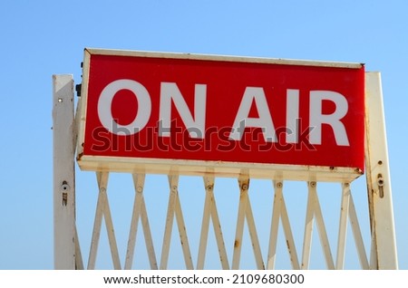 On air sign board. White letters on red background. 