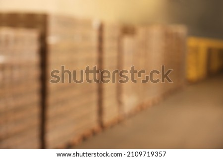 Warehouse with lots of products, blurred view. Wholesale business