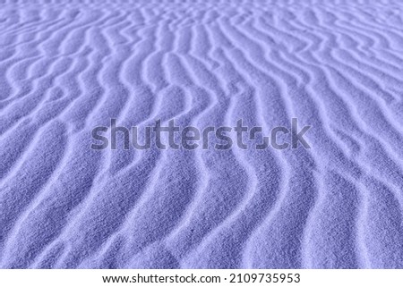 Close up of sand pattern of a vertical dunes. Macro sand. 2022 trending PANTONE 17-3938 Very Peri color