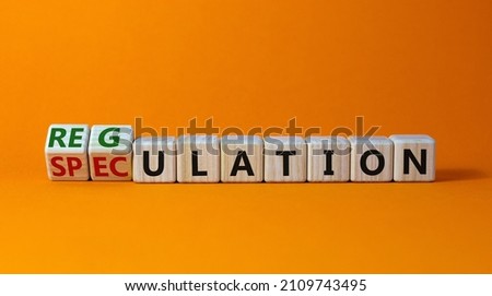 Speculation or regulation symbol. Turned cubes and changed the word speculation to regulation. Beautiful orange table, orange background, copy space. Business, speculation or regulation concept. Royalty-Free Stock Photo #2109743495