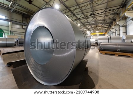 Closeup photo of metal tile for roof in metallic forming machine production line in factory. Cold rolled steel coils at the plant