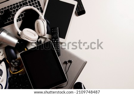 Old computers, digital tablets, mobile phones, many used electronic gadgets devices, broken household and appliances on white background. Planned obsolescence, electronic waste for recycling concept Royalty-Free Stock Photo #2109748487