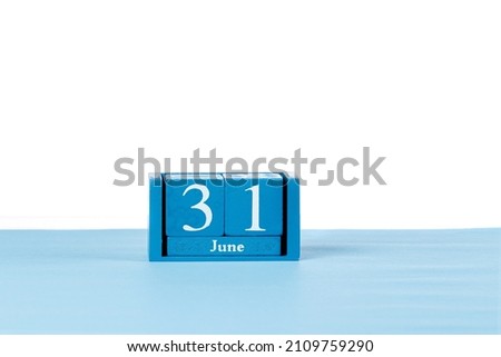 Wooden calendar June 31 on a white background close up