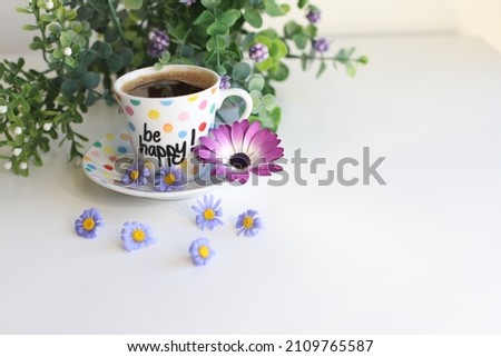 Turkish coffee with purple daisies and be happy text on it