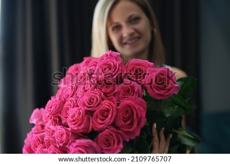Attractive young female hold bouquet of pink flowers on birthday or anniversary Royalty-Free Stock Photo #2109765707