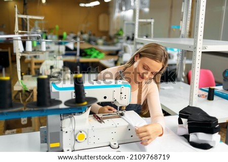 Portrait of seamstress working with sewing machine